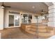 Covered patio boasts steps down to the yard with ceiling fans and access to the home's interior at 7616 Gossamer Wind St, Las Vegas, NV 89139