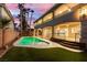 Backyard pool area with covered patio and lush landscaping at 7616 Gossamer Wind St, Las Vegas, NV 89139