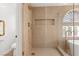 Bright shower features a glass enclosure with gold hardware and corner shelves at 7616 Gossamer Wind St, Las Vegas, NV 89139