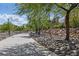 Beautiful walking path with natural rock landscaping and mature trees at 7616 Gossamer Wind St, Las Vegas, NV 89139