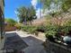 Landscaped backyard area with beautiful stone and brickwork, plus mature trees at 7733 Donner Peak St, Las Vegas, NV 89166