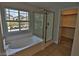 Bright bathroom featuring a soaking tub and glass-enclosed shower at 7733 Donner Peak St, Las Vegas, NV 89166