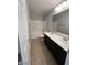 Standard bathroom featuring a double sink vanity and a shower-tub combo at 7733 Donner Peak St, Las Vegas, NV 89166