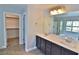 Bathroom with dual sinks, granite countertops, and a large mirror at 7733 Donner Peak St, Las Vegas, NV 89166