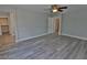 Spacious bedroom with gray walls, wood-look flooring, and ceiling fan at 7733 Donner Peak St, Las Vegas, NV 89166