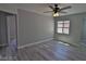 Bright bedroom with gray walls, wood-look flooring, and ceiling fan at 7733 Donner Peak St, Las Vegas, NV 89166
