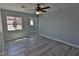 Bedroom with neutral walls, wood-look floors, and lots of natural light at 7733 Donner Peak St, Las Vegas, NV 89166