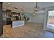Spacious kitchen with granite countertops, a central island, and a tile backsplash at 7733 Donner Peak St, Las Vegas, NV 89166