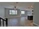 Open living room featuring wood-look tile flooring and lots of natural light at 7733 Donner Peak St, Las Vegas, NV 89166
