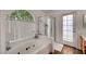 Bright bathroom featuring a jetted tub, walk-in shower, and natural light from a window at 7874 Trail Boss Ct, Las Vegas, NV 89113
