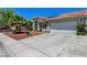 Charming single-story home with tile roof, desert landscaping, and wide driveway at 7874 Trail Boss Ct, Las Vegas, NV 89113