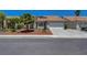 Charming single-story home featuring a landscaped front yard and a two-car garage at 7874 Trail Boss Ct, Las Vegas, NV 89113