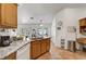 Bright kitchen featuring granite counters, oak cabinetry, and stainless steel appliances at 7874 Trail Boss Ct, Las Vegas, NV 89113