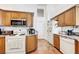 Functional kitchen with wooden cabinets and white appliances at 7874 Trail Boss Ct, Las Vegas, NV 89113