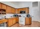 Functional kitchen with oak cabinets and white appliances at 7874 Trail Boss Ct, Las Vegas, NV 89113