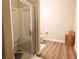 Bathroom with glass shower, a toilet, wood-look floors and a basket for storage at 8324 W Charleston Blvd # 1036, Las Vegas, NV 89117