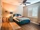 Comfortable bedroom with a blue bed, a ceiling fan and a window with shutters at 8324 W Charleston Blvd # 1036, Las Vegas, NV 89117