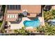 Aerial view of a private backyard with a sparkling pool, covered patio, and lush landscaping at 8326 Mount Nido Dr, Las Vegas, NV 89147
