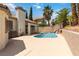 Wide backyard featuring a covered patio, sparkling pool, and mature trees at 8326 Mount Nido Dr, Las Vegas, NV 89147