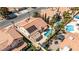 Serene backyard featuring a sparkling swimming pool, covered patio, lush landscaping, and inviting outdoor seating areas at 8326 Mount Nido Dr, Las Vegas, NV 89147