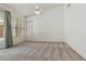 Bright bedroom with neutral carpet, a ceiling fan, large windows, and light walls at 8326 Mount Nido Dr, Las Vegas, NV 89147