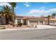 Attractive home features a three-car garage, desert landscaping, and a classic tile roof at 8326 Mount Nido Dr, Las Vegas, NV 89147