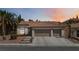 Charming single-story home features a three-car garage, desert landscaping, and a tile roof at 8326 Mount Nido Dr, Las Vegas, NV 89147