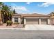 Beautiful single-story home with a three-car garage, desert landscaping, and a tile roof at 8326 Mount Nido Dr, Las Vegas, NV 89147
