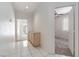 Entryway with cabinet and white tiled flooring that leads to a bedroom and bathroom at 8326 Mount Nido Dr, Las Vegas, NV 89147