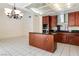 A chef's kitchen featuring a center island, and white tile flooring at 8326 Mount Nido Dr, Las Vegas, NV 89147
