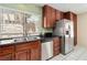 Well-equipped kitchen with stainless steel appliances, wood cabinets, and tile flooring at 8326 Mount Nido Dr, Las Vegas, NV 89147