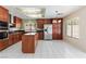 Well-lit kitchen with stainless steel appliances, wooden cabinets, and tiled floors at 8326 Mount Nido Dr, Las Vegas, NV 89147