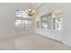 Open living room featuring tile flooring, built-in cabinets, and decorative chandelier at 8326 Mount Nido Dr, Las Vegas, NV 89147