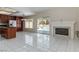 Bright open living area with fireplace, tile flooring, and sliding doors to the pool at 8326 Mount Nido Dr, Las Vegas, NV 89147
