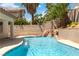 Enjoy a refreshing pool with a waterfall feature and lush tropical landscaping in this backyard oasis at 8326 Mount Nido Dr, Las Vegas, NV 89147