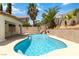 Beautiful blue pool with a rock waterfall feature in a private backyard at 8326 Mount Nido Dr, Las Vegas, NV 89147