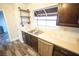 Well-lit kitchen area featuring stainless steel appliances, custom open shelving, and a modern double sink at 9000 Litchfield Ave, Las Vegas, NV 89134