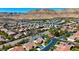 Aerial shot displays a neighborhood house, manicured lawns, backyard pools, and desert landscape providing a tranquil living environment at 10089 Clifton Forge Ave, Las Vegas, NV 89148