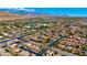 Panoramic aerial showcases a neighborhood with houses, nearby school, streets, and distant mountain range at 10089 Clifton Forge Ave, Las Vegas, NV 89148