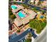 Aerial view showcasing the community pool, playground, parking, and lush green landscape at 10089 Clifton Forge Ave, Las Vegas, NV 89148