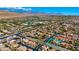 Beautiful aerial view showing nearby schools, houses, streets, solar panels, and desert scenery for a perfect community at 10089 Clifton Forge Ave, Las Vegas, NV 89148