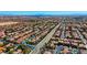 Expansive aerial view highlights a residential community, with many homes featuring solar panels and private pools at 10089 Clifton Forge Ave, Las Vegas, NV 89148