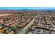 Wide aerial captures a community with neatly arranged homes, offering a sense of peaceful suburban living on a sunny day at 10089 Clifton Forge Ave, Las Vegas, NV 89148