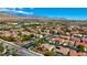 Expansive aerial view of a residential neighborhood featuring single-Gathering homes, streets, and mountain views in the distance at 10089 Clifton Forge Ave, Las Vegas, NV 89148