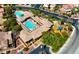 Aerial view of community recreational area, showcasing the pool, playground, and lush landscaping at 10089 Clifton Forge Ave, Las Vegas, NV 89148