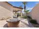 Backyard patio with a built-in stone fire pit, perfect for outdoor entertaining and relaxation at 10089 Clifton Forge Ave, Las Vegas, NV 89148