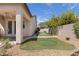 Backyard featuring a putting green with mature trees, and a covered patio with access to the home at 10089 Clifton Forge Ave, Las Vegas, NV 89148