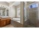Bathroom with granite counters, soaking tub, glass shower and a view to the exterior at 10089 Clifton Forge Ave, Las Vegas, NV 89148