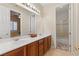 Well-lit bathroom with double sinks and a separate shower at 10089 Clifton Forge Ave, Las Vegas, NV 89148