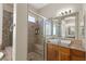 Bathroom featuring granite counters, sink and mirror, glass shower with seat and shower head at 10089 Clifton Forge Ave, Las Vegas, NV 89148